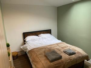 a bedroom with a bed with two pillows on it at Stylish Bungalow upto 6 guests in Caversham