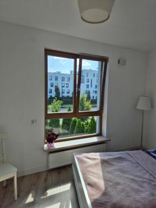 Ένα ή περισσότερα κρεβάτια σε δωμάτιο στο Apartment Wilanow Branickiego