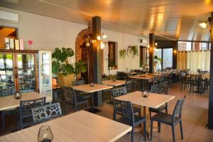 a restaurant with tables and chairs in a room at La Plaza B&B in Cavaglià