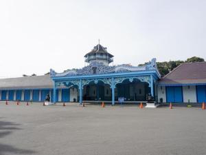 a blue building with a tower on top of it at Larisae Setia Kawan Hotel in Solo