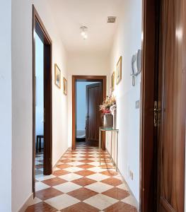 a hallway with a checkered floor and an open door at Venice Secret Garden view in Venice +6 photos