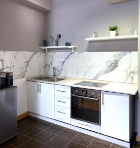 a kitchen with a sink and a counter top at SPACE APART ASTANA просторные студии в центральном районе у монумента Байтерек in Astana