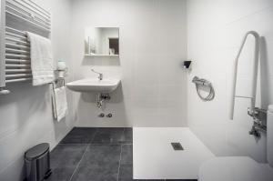 a white bathroom with a sink and a toilet at Casual Serantes in Bilbao +41 photos