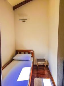 a small room with a bed and a stool at Prima Casa in Kotor