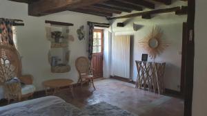 a bedroom with a table and chairs and a room with a bed at Le domaine du chêne vert in Monthou-sur-Bièvre +16 photos