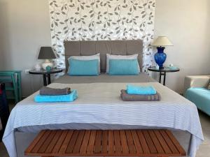a bedroom with a large bed with two pillows on it at Kiparissi suit in Evdilos