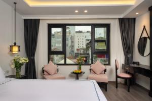 Postel nebo postele na pokoji v ubytování SQ Hang Gai hotel & Spa