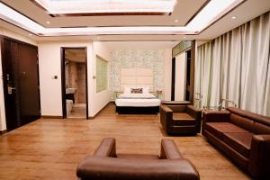 a living room with a couch and a bed at Royal Residence Dhaka in Dhaka +167 photos