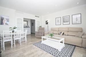 a living room with a couch and a table at Del Parque Flats Family Paradise in Rincón de la Victoria