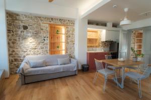 a living room with a couch and a table at Eligia Suites in Ioannina
