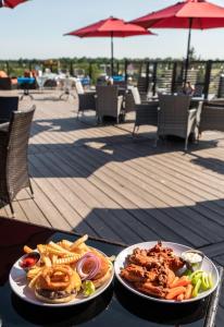 two plates of food on a table on a deck at Holiday Inn Express - Grand Island by IHG in Niagara Falls