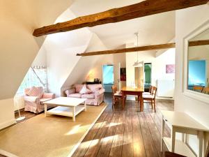 a living room with a table and a couch at Altes Standesamt Große Wohnung in Oldsum