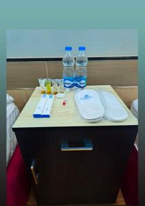 a table with bottles of water and glasses on it at Family Inn - Airport Hotel in Dhaka +10 photos