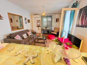 a living room with a couch and a table at Robinson House Destina in Bogomolje