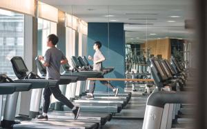 two people running on treadmills in a gym at EAST Beijing in Beijing