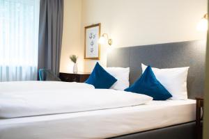 Postel nebo postele na pokoji v ubytování Hotel Altmünchen by Blattl