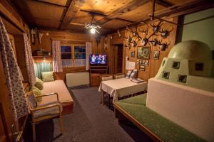 a living room with a couch and a tv at Ferienhaus Jägerhäusl in Lermoos