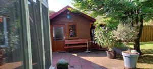 a small wooden cabin with a bench in a yard at Ferienhaus "Haus Bethlehem" Käthe Schmidt in Papenburg