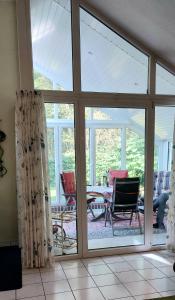 a living room with a sliding glass door at Ferienhaus "Haus Bethlehem" Käthe Schmidt in Papenburg