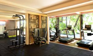 a gym with treadmills and exercise equipment in a room at JOALI Maldives in Raa Atoll