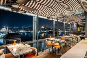 a bar with a view of the city at night at Hotel Momento Golden Horn in Istanbul