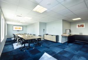 a conference room with a long table and chairs at Sudima Auckland Airport in Auckland
