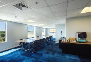 a conference room with a long table and chairs at Sudima Auckland Airport in Auckland
