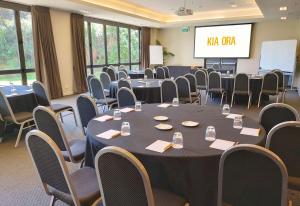 a conference room with a large table and chairs at Sudima Auckland Airport in Auckland