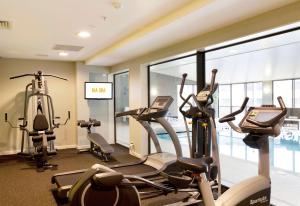 a gym with treadmills and ellipticals in a building at Sudima Auckland Airport in Auckland