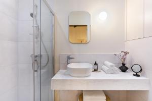 a bathroom with a sink and a shower at Historic Apartments - SUPER location near Valletta Ferry in Cospicua