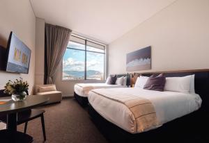 Sudima Queenstown Five Mile客房内的一张或多张床位