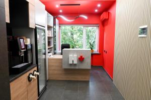 an office with red walls and a desk in a room at Hostel H in Rivne