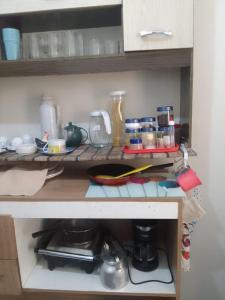 a kitchen with a counter with food on it at Apto Casa A Simples, Central e Aconchegante in Corumbá +16 photos