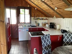 a kitchen with red cabinets and a white stove at Ferienhaus Gartow in Gartow
