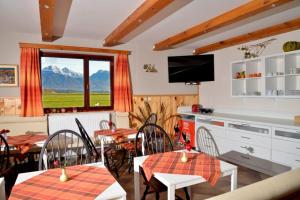 a dining room with a table and chairs and a window at Bed and Breakfast Valjavec in Kranj