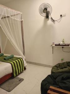 Postel nebo postele na pokoji v ubytování Rich Grove Inn