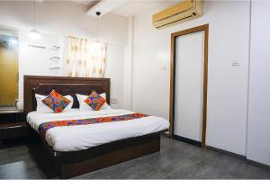 Postel nebo postele na pokoji v ubytování FabHotel Shree Haree Residency - Nr Mazda Garden View
