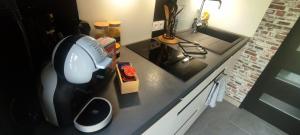a kitchen counter with a mixer and a sink at Le petit chez soi in Le Portel +8 photos