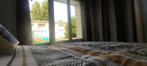 a bedroom with a bed and a window with a view at Le petit chez soi in Le Portel