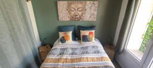 a bedroom with a bed with a picture on the wall at Le petit chez soi in Le Portel +28 photos