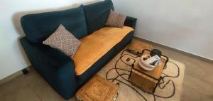 a blue couch with pillows on it in a room at Le petit chez soi in Le Portel