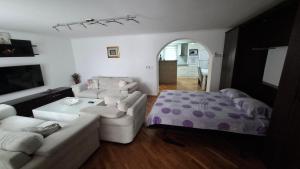 a living room with a couch and a bed at City Gate in Sarajevo