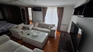 a living room with a couch and a table at City Gate in Sarajevo
