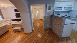 a kitchen and a living room with a couch and a table at City Gate in Sarajevo
