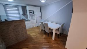 a small kitchen with a white table and chairs at City Gate in Sarajevo +14 photos