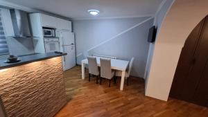 a kitchen with a table and chairs in a room at City Gate in Sarajevo