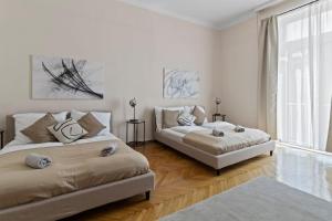 Un dormitorio con dos camas y una gran ventana. en At Belvedere, Top Location Close to U1, en Viena