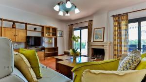 a living room with a couch and a table at Greice Homes-650 meters from the beach, 4 bedrooms villa for holidays in Vilamoura-Quarteira in Quarteira