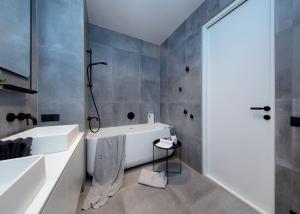 a bathroom with a white tub and a sink at Exclusive apartment in Heart of Town in Vanalinn +11 photos