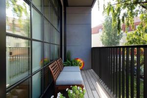 a porch with a bench on a balcony at Exclusive apartment in Heart of Town in Vanalinn